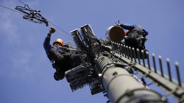 Engineers scale a Swisscom AG telecommunication network mast to install Ericsson AB 5G apparatus in Hindelbank, Switzerland. Photographer: Stefan Wermuth/Bloomberg