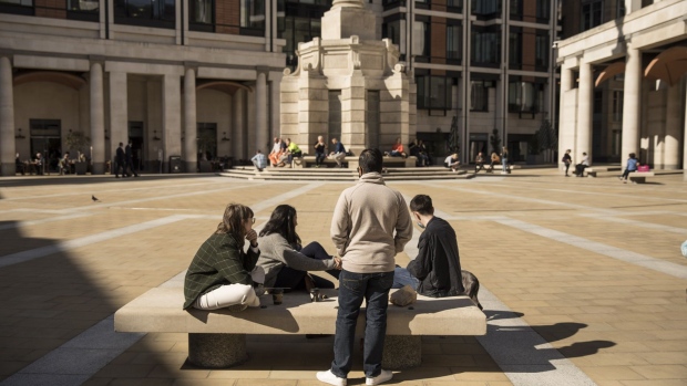 Pedestrian sit in Paternoster Square in the City of London, U.K., on Monday, Sept. 28, 2020. Londoners are looking for jobs outside the capital as the city struggles to generate new work after the coronavirus slump.