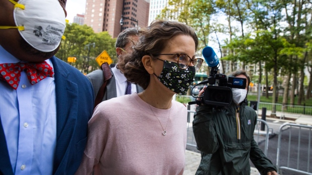 Clare Bronfman, daughter of former Seagram Chairman Edgar M. Bronfman, center, arrives at federal court in the Brooklyn borough of New York, U.S., on Wednesday, Sept. 30, 2020. Bronfman was charged with helping finance the activities of Nxivm, an upstate New York cult accused of branding its victims and forcing them to participate in sex acts. She pleaded guilty to conspiracy charges and could spend more than two years in federal prison.