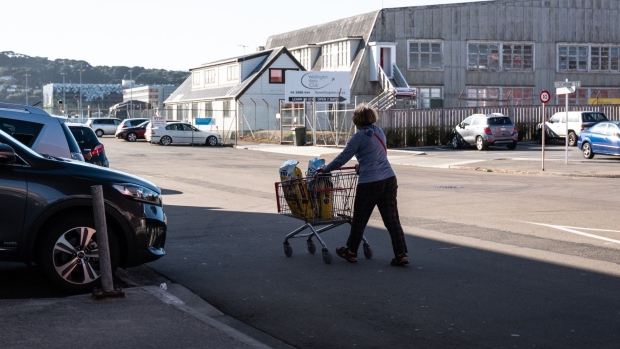 A customer pushes a cart to the parking area in Wellington, New Zealand.
