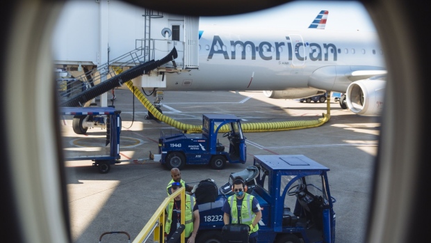 Workers load bags onto an American Airlines flight at Dallas/Fort Worth International Airport (DFW) on Sept. 28, 2020.