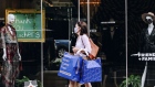 A pedestrian wearing a protective mask carries shopping bags past an Alice And Olivia store on Madison Avenue in New York, U.S., on Saturday, Sept. 26, 2020. The pandemic has battered New York City businesses, with almost 6,000 closures, a jump of about 40% in bankruptcy filings across the region and shuttered storefronts in the business districts of all five boroughs. Photographer: Nina Westervelt/Bloomberg