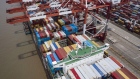 A vessel loaded with shipping containers is docked at the Yangshan Deepwater Port in this aerial photograph taken in Shanghai, China, on Sunday, July 12, 2020. U.S. President Donald Trump said Friday a phase two trade deal with China isn't under consideration, saying the relationship between Washington and Beijing has deteriorated too much. Photographer: Qilai Shen/Bloomberg
