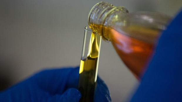 An employee pours a sample of oil into a test tube in the control laboratory at the Royal Dutch Shell Plc lubricants blending plant in Torzhok, Russia, on Wednesday, Feb. 7, 2018. The oil-price rally worked both ways for Royal Dutch Shell Plc as improved exploration and production lifted profit to a three-year high while refining and trading fell short of expectations as margins shrank. Photographer: Andrey Rudakov/Bloomberg