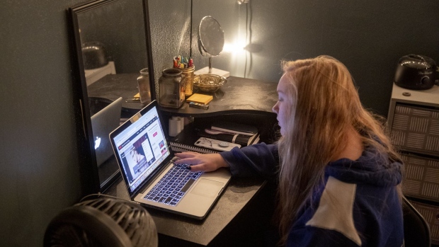A student listens to a live lecture on a laptop computer at home during a remote learning class in Princeton, Illinois, U.S., on Friday, Sept. 11, 2020. Illinois reported 1,337 new coronavirus cases Wednesday as the state's positivity rate dropped below 4% for the first time in weeks.