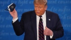 U.S. President Donald Trump holds a protective mask during the first U.S. presidential debate hosted by Case Western Reserve University and the Cleveland Clinic in Cleveland, Ohio, U.S., on Tuesday, Sept. 29, 2020. Trump and Biden kick off their first debate with contentious topics like the Supreme Court and the coronavirus pandemic suddenly joined by yet another potentially explosive question -- whether the president ducked paying his taxes.