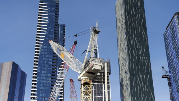 Cranes stand in Melbourne, Australia, on Tuesday, Sept. 1, 2020. A twin-speed economy is developing in Australia and posing a challenge for the central bank, as Chinese demand for iron ore buoys the resource-rich west while eastern states struggle with Covid-19 outbreaks and border closures. Photographer: Carla Gottgens/Bloomberg