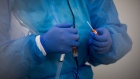 A One Medical Group Inc. nurse practitioner places a swab inside a test tube after swabbing a patient at a Covid-19 testing center
