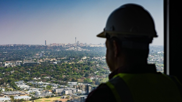A construction worker looks out towards the Central Business District (CBD) on the city skyline from inside The Leonardo, the Legacy Group’s mixed-use property development, currently Africa’s tallest building, in the Sandton district of Johannesburg, South Africa, on Tuesday, Sept. 17, 2019. Emerging markets will again be looking to central banks to provide the next leg-up in a rally that’s making it the best September so far for stocks and currencies since 2013. Photographer: Waldo Swiegers/Bloomberg