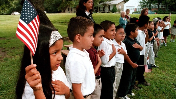 TYLER,TX - SEPTEMBER 11: A class of Hispanic students recites the Pledge of Allegiance during a September 11 memorial service at Birdwell Elementary School September 11, 2003 in Tyler, Texas. Birdwell has a student body of 600 youngsters, with 60 percent of them being Hispanic. Among the other schools in the Tyler Independent School District, 30 percent of the 17,550 students are Hispanic, according to school district administrators. (Photo by Mario Villafuerte/Getty Images)