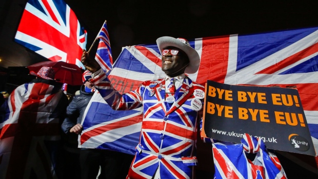 A reveler wears a Union flag, also known as a Union Jack, suit during the Leave Means Leave celebration at Parliament Square in London, U.K., on Friday, Jan. 31, 2020. After more than three years of bickering and political gridlock the U.K. is scheduled to leave the European Union, ushering in what U.K. Prime Minister Boris Johnson's government is calling a new era of sweeping free-trade deals and investment. Photographer: Luke MacGregor/Bloomberg