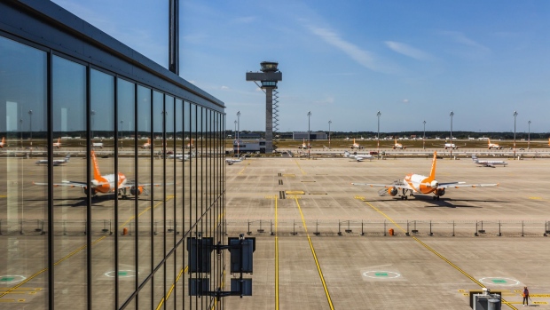 Passenger aircraft, operated by easyJet Plc, stand on the tarmac near the flight control tower at Berlin Brandenburg Airport (BER), operated by Flughafen Berlin Brandenburg GmbH, in Berlin, Germany, on Thursday, July 30, 2020. The German capital’s BER airport, which was originally scheduled to open in October 2011, will have its inaugural flight on Oct. 31. Photographer: Rolf Schulten/Bloomberg
