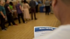 A job seeker holds an employment flier during a hiring event at an Aldi Supermarket in Darien, Illinois, U.S., on Tuesday, July 17, 2018. Unemployment lines across the U.S. last week were the shortest since December 1969, according to a Labor Department report Thursday that showed an unexpected drop in filings for jobless benefits. Photographer: Daniel Acker/Bloomberg