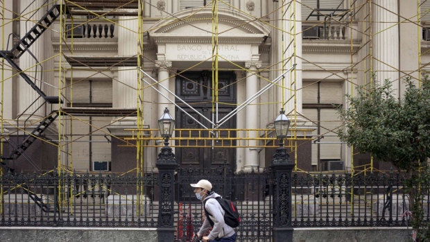 A cyclist wearing a protective mask cycles past the Central Bank of Argentina in Buenos Aires, Argentina, on Friday, June 19, 2020. Coronavirus cases may peak in Argentina sometime between the end of June and beginning of July despite cases and virus-related deaths increasing at a faster pace, according to Health Minister Gines Gonzalez Garcia.