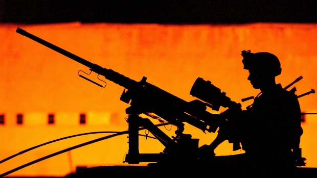 MOSUL, IRAQ - JULY 27: A soldier with the U.S. Army 101st Airborne 3-502 is silhouetted manning a 50 caliber humvee-mounted machine gun as his squad heads out on a nighttime mission July 27, 2003 in Mosul, Iraq. Soldiers from the 101st continue to conduct presence patrols and random vehicle checkpoints throughout the Mosul area in order to reduce the number of attacks on American troops there and to improve overall security in the area. (Photo by Scott Nelson/Getty Images)