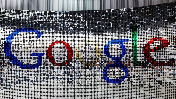 A sign featuring Google Inc.'s logo stands inside the entrance to their U.K. headquarters at Six St Pancras Square in London. Photographer: Chris Ratcliffe/Bloomberg