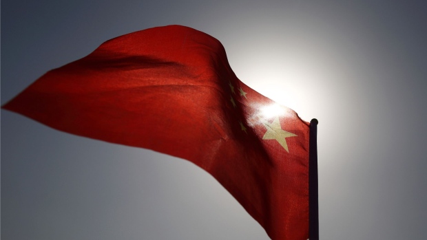A Chinese national flag flies in Beijing, China, on Monday, March 2, 2015. China's annual meeting of the National People's Congress, which begins March 5 in Beijing, is expected to set government policies for the year on issues ranging from economic growth to military spending and pollution. Photographer: Tomohiro Ohsumi