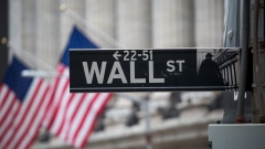 A Wall Street sign d in front of New York Stock Exchange. Photographer: Michael Nagle/Bloomberg