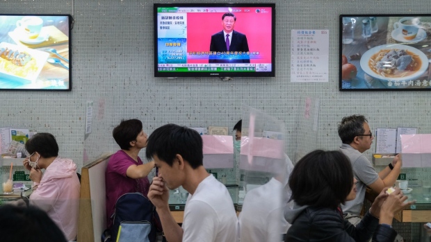 A live broadcast of President Xi Jinping delivering a speech is shown on a screen inside a restaurant in Hong Kong, Oct. 14.