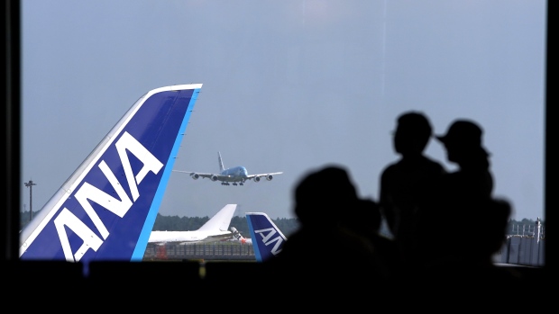 All Nippon Airways Co. (ANA) aircraft stand as an airplane lands at Narita Airport in Narita, Chiba Prefecture, Japan, on Monday, Aug. 26, 2019. The decline in South Korean tourists in July dented an otherwise positive result, with the total number of visitors to Japan climbing 5.6% from a year earlier. Photographer: Toru Hanai/Bloomberg