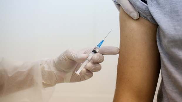 A heath worker prepares to inject the 'Gam-COVID-Vac', also known as 'Sputnik V', COVID-19 vaccine, developed by the Gamaleya National Research Center for Epidemiology and Microbiology and the Russian Direct Investment Fund (RDIF), into a patient's arm during a post-registration phase trial at the City Clinic #46 in Moscow on Sept. 23.