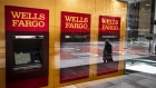 A person wearing a protective mask is reflected in the window of a temporarily closed Wells Fargo & Co. Bank branch in New York, U.S., on Friday, April 10, 2020. Wells Fargo is scheduled to release earnings figures on April 14. Photographer: Mark Kauzlarich/Bloomberg