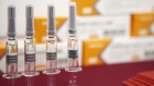Vials of Sinovac Biotech Ltd.'s CoronaVac SARS-CoV-2 vaccine are displayed at a media event in Beijing, China, on Thursday, Sept. 24, 2020. Chinese vaccine developer Sinovac said that countries running its final-stage clinical trials like Brazil, Indonesia and Turkey will get its coronavirus shots at the same time as China, underscoring how vaccine supply agreements could cement diplomatic ties in the Covid-19 era.