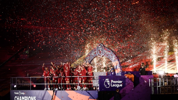 LIVERPOOL, ENGLAND - JULY 22: Jordan Henderson of Liverpool holds the Premier League Trophy aloft as they celebrate winning the League during the presentation ceremony of the Premier League match between Liverpool FC and Chelsea FC at Anfield on July 22, 2020 in Liverpool, England. Football Stadiums around Europe remain empty due to the Coronavirus Pandemic as Government social distancing laws prohibit fans inside venues resulting in games being played behind closed doors. (Photo by Laurence Griffiths/Getty Images)