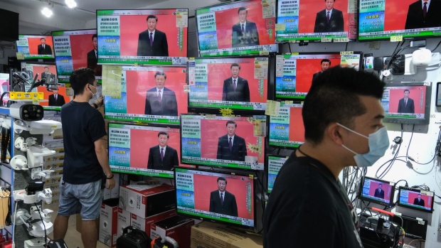 President Xi Jinping's speech in Shenzhen is broadcasted inside a store in Hong Kong, Oct. 14.