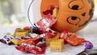 Mars Inc. and Hershey Co. brand Halloween candy is displayed for a photograph beside a pumpkin themed treat bucket in Tiskilwa, Illinois, U.S., on Sunday, Sept. 20, 2020. Costume-sellers appear to be facing one of their scariest fall seasons in a long time, even as confectioners could see sales hold steady from past years, with some candy brands even expecting an uptick. Photographer: Daniel Acker/Bloomberg