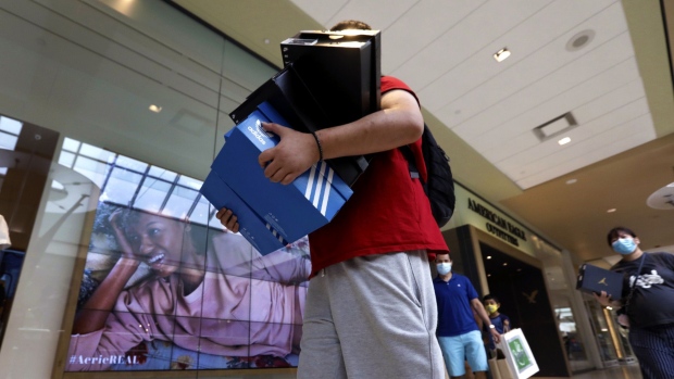 A shopper carries boxes of shoes at the Queens Center shopping mall in the Queens borough of New York on Sept. 9.