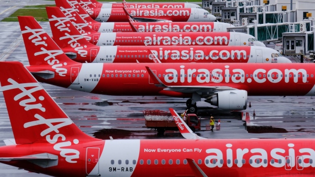 AirAsia Bhd. aircraft stand on the tarmac at Kuala Lumpur International Airport 2 (KLIA2) during a partial lockdown imposed due to the coronavirus in Sepang, Selangor, Malaysia. on Wednesday, May 13, 2020. Malaysia has extended its relaxed lockdown by four weeks, allowing nearly all economic activities to continue while keeping its borders shut and schools closed. Photographer: Samsul Said/Bloomberg
