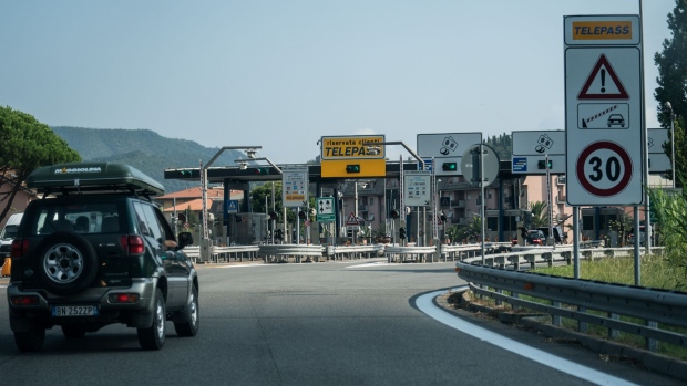 A sport utility vehicle (SUV) approaches a toll booth on the A12 Highway operated by Autostrade per l'Italia SpA. near Genoa, Italy, on Friday, Aug. 24, 2018. Italy's Deputy Prime Minister Matteo Salvini signaled support for a political compromise taking shape following last week's Genoa bridge collapse, saying he favored a government ownership role in toll-road operator Autostrade per l’Italia, but opposed nationalizing the highway network. Photographer: Federico Bernini/Bloomberg