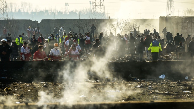 Rescue workers search the smouldering wreckage of a Boeing Co. 737-800 aircraft, operated by Ukraine International Airlines, which crashed shortly after takeoff near Shahedshahr, Iran, on Wednesday, Jan. 8, 2020. The passenger jet, Flight 752, bound for Ukraine crashed shortly after takeoff in Iran, killing everyone on board. Photographer: Ali Mohammadi/Bloomberg