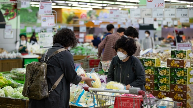 Customers check cabbages at a Hanaro Mart supermarket in Seoul on May 14.