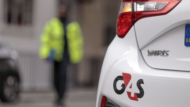 A G4S Plc logo sits on an automobile outside one of the company's offices in London, U.K., on Monday, Sept. 21, 2020. Harris Associates, one of the largest shareholders in G4S Plc, said it values the U.K. security group "significantly higher" than a roughly 2.9 billion-pound ($3.7 billion) takeover offer from Canadian peer GardaWorld. Photographer: Jason Alden/Bloomberg