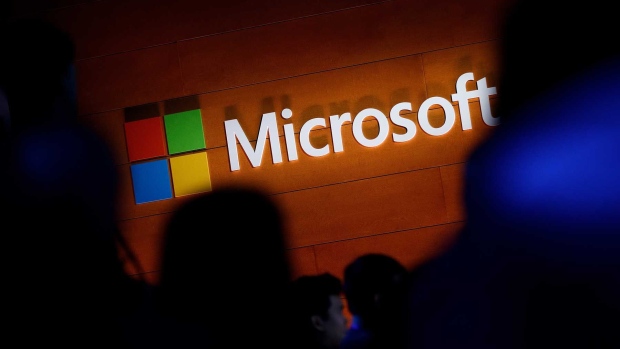 The Microsoft logo is illuminated on a wall during a Microsoft launch event to introduce the new Microsoft Surface laptop and Windows 10 S operating system, May 2, 2017 in New York City. The Windows 10 S operating system is geared toward the education market and is Microsoft's answer to Google's Chrome OS. (Photo by Drew Angerer/Getty Images) Photographer: Drew Angerer/Getty Images North America