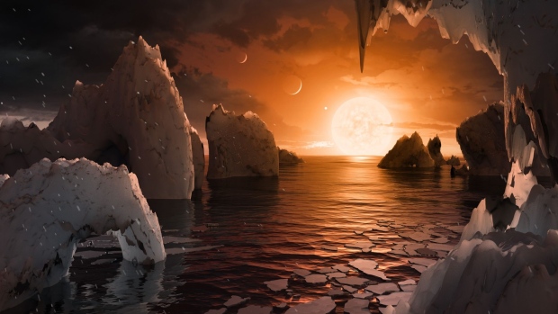 UNSPECIFIED: In this NASA digital illustration handout released on February 22, 2017, an artist's concept allows us to imagine what it would be like to stand on the surface of the exoplanet TRAPPIST-1f, located in the TRAPPIST-1 system in the constellation Aquarius. Because this planet is thought to be tidally locked to its star, meaning the same face of the planet is always pointed at the star, there would be a region called the terminator that perpetually divides day and night. If the night side is icy, the day side might give way to liquid water in the area where sufficient starlight hits the surface. One of the unusual features of TRAPPIST-1 planets is how close they are to each other -- so close that other planets could be visible in the sky from the surface of each one. In this view, the planets in the sky correspond to TRAPPIST1e (top left crescent), d (middle crescent) and c (bright dot to the lower right of the crescents). TRAPPIST-1e would appear about the same size as the moon and TRAPPIST1-c is on the far side of the star. The star itself, an ultra-cool dwarf, would appear about three times larger than our own sun does in Earth's skies. The system has been revealed through observations from NASA's Spitzer Space Telescope as well as other ground-based observatories, and the ground-based TRAPPIST telescope for which it was named after. (Photo digital Illustration by NASA/NASA via Getty Images)
