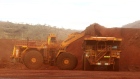An excavator loads ore into an autonomous dump truck at Fortescue Metals Group Ltd.'s Solomon Hub mining operations in the Pilbara region, Australia, on Thursday, Oct. 27, 2016. Shares in Fortescue, the world's No. 4 iron ore exporter, have almost trebled in 2016 as iron ore recovered, and the company cut costs and repaid debt. Photographer: Brendon Thorne/Bloomberg
