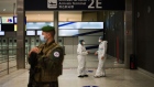 A French soldier stands guard near health workers at the Covid-19 test center in the arrival hall at Charles de Gaulle airport, operated by Airport de Paris, in Roissy, France, on Tuesday, Oct. 6, 2020. The European Union’s battered aviation industry may soon get some relief from the confusingly wide range of travel curbs across the continent, as the bloc’s governments seek agreement on a common threshold for imposing restrictions.