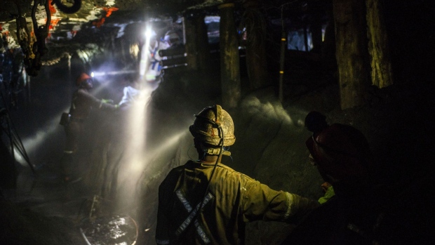 Lights from miners safety helmets illuminate the mine shaft during a media tour of the Sibanye-Stillwater Khuseleka platinum mine, operated by Sibanye Gold Ltd., outside Rustenburg, South Africa on Wednesday, Oct. 16 2019. Sibanye said it’s on track to resume paying dividends next year, should the company settle a wage dispute with platinum-mine workers without too much disruption. Photographer: Waldo Swiegers/Bloomberg