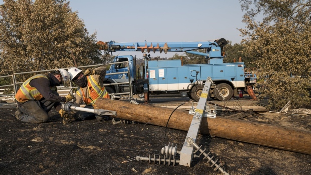 Pacific Gas & Electric Co. workers prepare a power pole to replace one destroyed by the LNU Lightning Complex fire in Vacaville, California, U.S., on Tuesday, Aug. 25, 2020. More than 7,000 blazes have hit California this year, a 63% jump from 2019, according to Governor Gavin Newsom. Photographer: David Paul Morris/Bloomberg