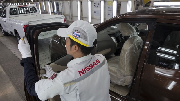A worker inspects the door of a Nissan Motor Co. Navara pickup truck on an assembly line at the company's plant in Samut Prakan, Thailand, on Tuesday, April 25, 2017. Nissan and Mitsubishi Motors Corp. still have a small presence in Southeast Asia and the two alliance partners can target to at least double their current market share, said Carlos Ghosn, who’s chairman of both companies. Photographer: Brent Lewin/Bloomberg