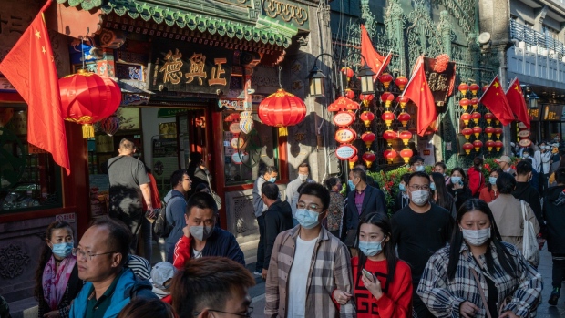 Visitors walk in Qianmen area in Beijing, China on Sunday, Oct. 4, 2020. A significant rebound in domestic travel over the Golden Week holiday is fueling optimism that consumers are starting to spend again after the pandemic-induced slump.