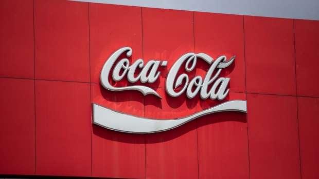 The Coca-Cola Co. logo is displayed at the Coca-Cola Cambodia Bottling Plant, operated by Cambodia Beverage Co. which is a subsidiary of Coca-Cola, in Phnom Penh, Cambodia, on Tuesday, May 28, 2019. Coca-Cola, locked in a renewed battle for global beverage sales with rival PepsiCo Inc., got a boost from better sales last quarter. Global unit case volume, a key measure for Coke, rose 2 percent, fueled by a 7 percent spike in Asia Pacific. Photographer: Taylor Weidman/Bloomberg