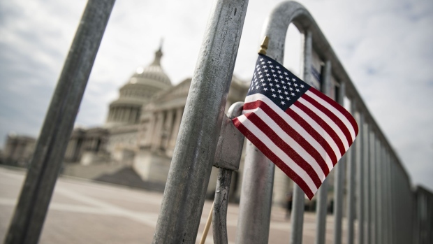 WASHINGTON, DC - SEPTEMBER 28: An American flag is placed on a fence outside of the U.S. Capitol building on September 28, 2020 in Washington, DC. This week Seventh U.S. Circuit Court Judge Amy Coney Barrett, U.S. President Donald Trump's nominee to the Supreme Court, will begin meeting with Senators as she seeks to be confirmed before the presidential election. (Photo by Al Drago/Getty Images) Photographer: Al Drago/Getty Images North America