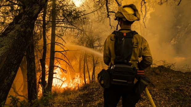 A firefighter ignites a controlled burn during the Glass Fire near Calistoga, California, U.S., on Friday, Oct. 2, 2020. Even as firefighters in Northern Californias wine country battle a blaze that forced the evacuation of entire towns, a forecast of extreme heat and dry winds threatens to breath new life into the inferno. Photographer: Philip Pacheco/Bloomberg