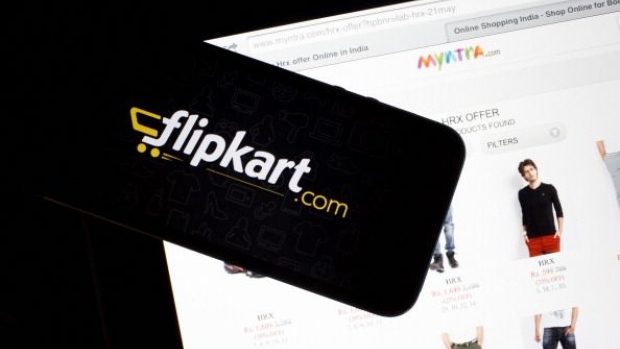 Flipkart's application loading page, left, and the Myntra.com website are displayed on an Apple Inc. iPhone 5c and iPad respectively an arranged photograph in Hong Kong, China, on Wednesday, May 21, 2014. Flipkart, India's largest online retailer, will buy competitor Myntra.com, according to people with knowledge of the talks, to gain a business with higher margins and strengthen its position in the local market against Amazon.com Inc. Photographer: Bloomberg/Bloomberg