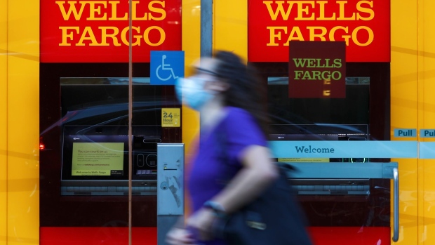 A pedestrian wearing a protective mask walks past a Wells Fargo & Co. bank branch in New York, U.S., on Thursday, July 9, 2020. Wells Fargo is scheduled to release earnings figures on July 14. Photographer: Peter Foley/Bloomberg