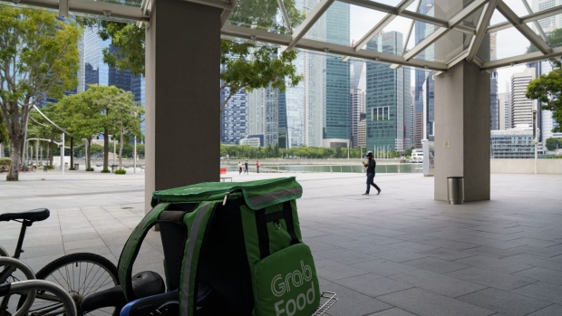 A bicycle for a delivery driver for GrabFood, Grab Holdings Inc.'s online food-delivery platform, is seen parked at the Marina Bay Sands in Singapore, on Friday, Sept. 25, 2020. Alibaba Group Holding Ltd. is in talks to invest $3 billion in Southeast Asian ride-hailing giant Grab, according to people familiar with the matter. Photographer: Ore Huiying/Bloomberg